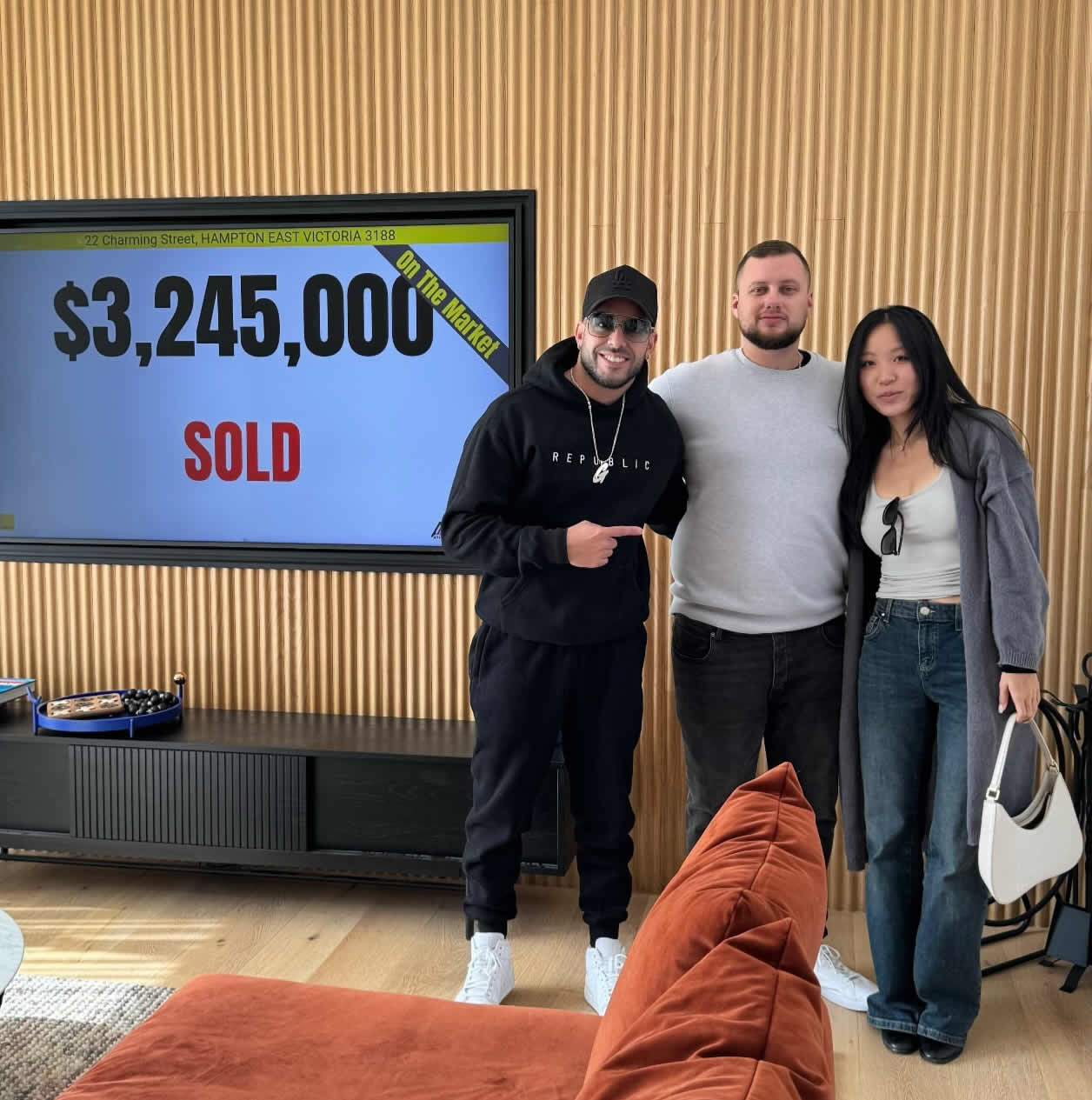 Adrian Portelli with the purchasers of 22 Charming Street following the auction
